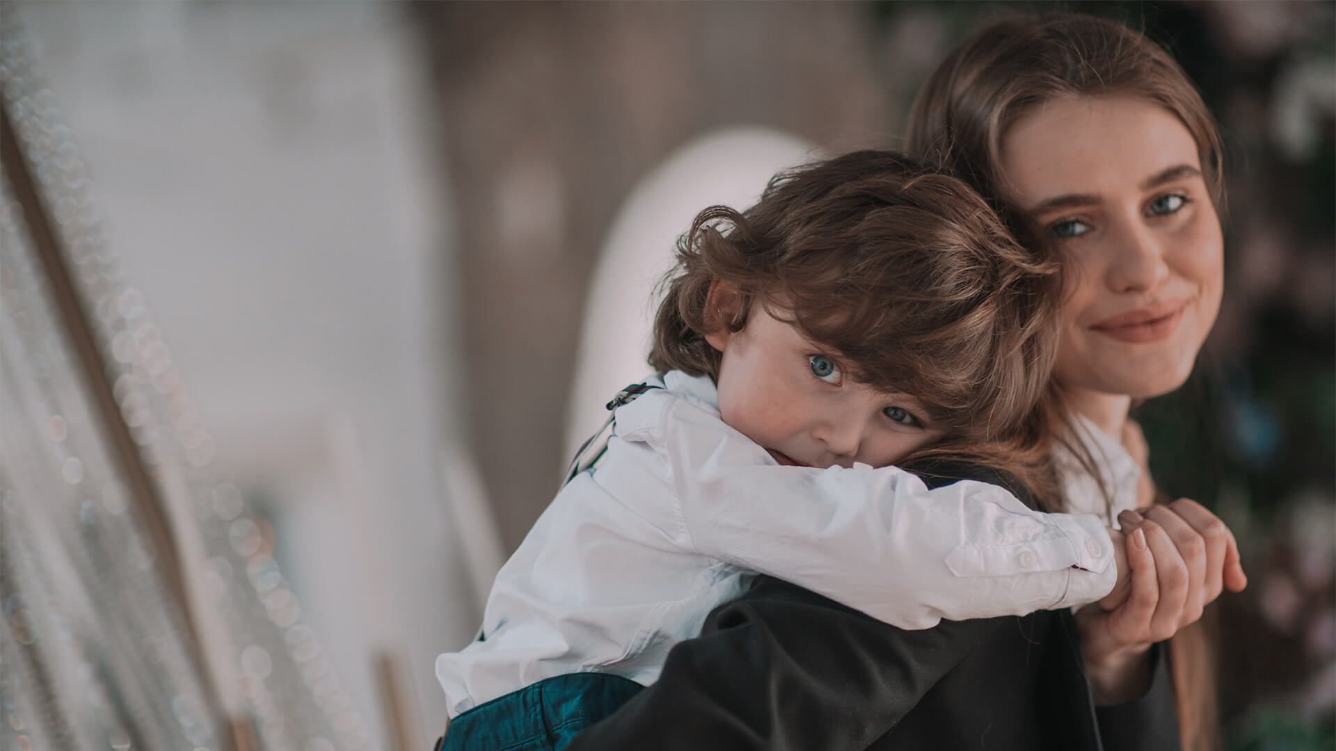 Mother holding her young child closely, both smiling softly — representing care, stability, and positive parenting agreements at Resolve Divorce Adelaide.