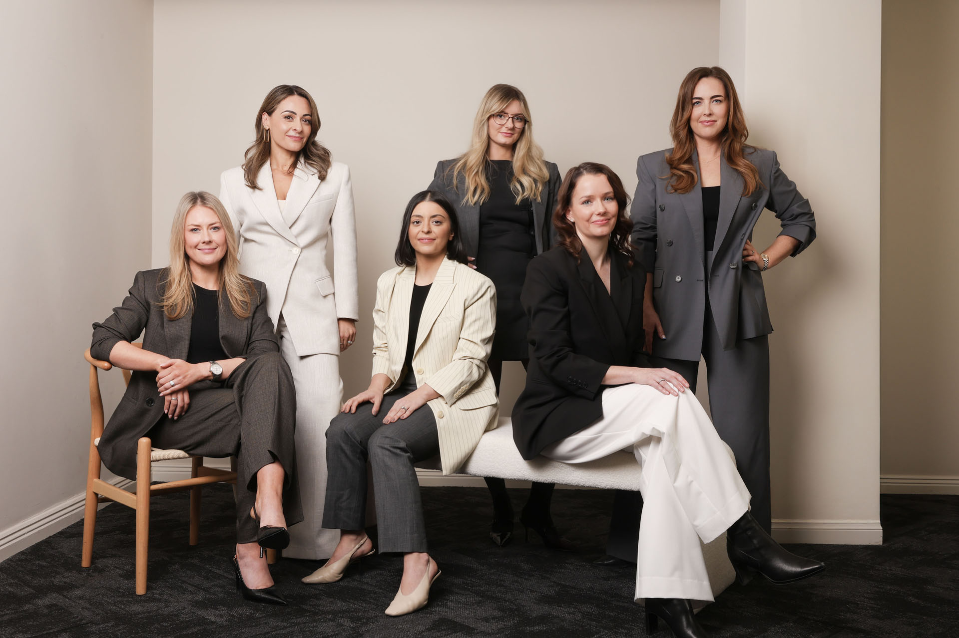 Adelaide family law firm Resolve Divorce team in professional suits, posing together in a modern office.